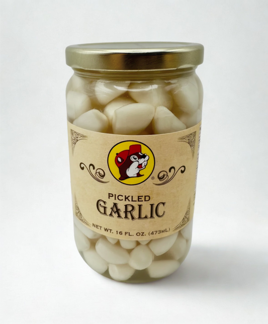 Jar of pickled garlic on a wooden surface