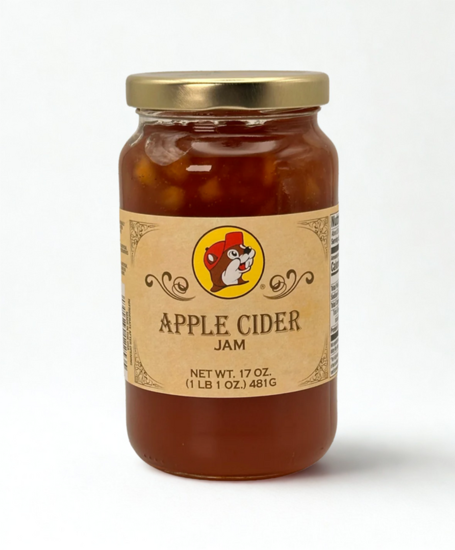 Jar of apple cider jam with a label on a wooden surface