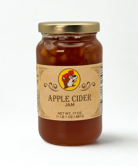 Jar of apple cider jam with a label on a wooden surface