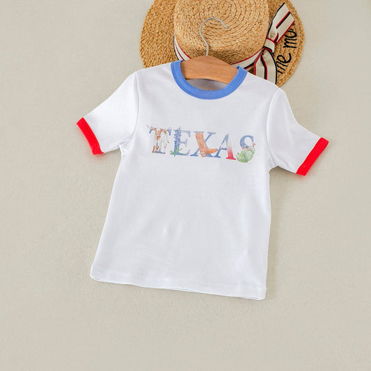 White t-shirt with 'TEXAS' print on a beige background