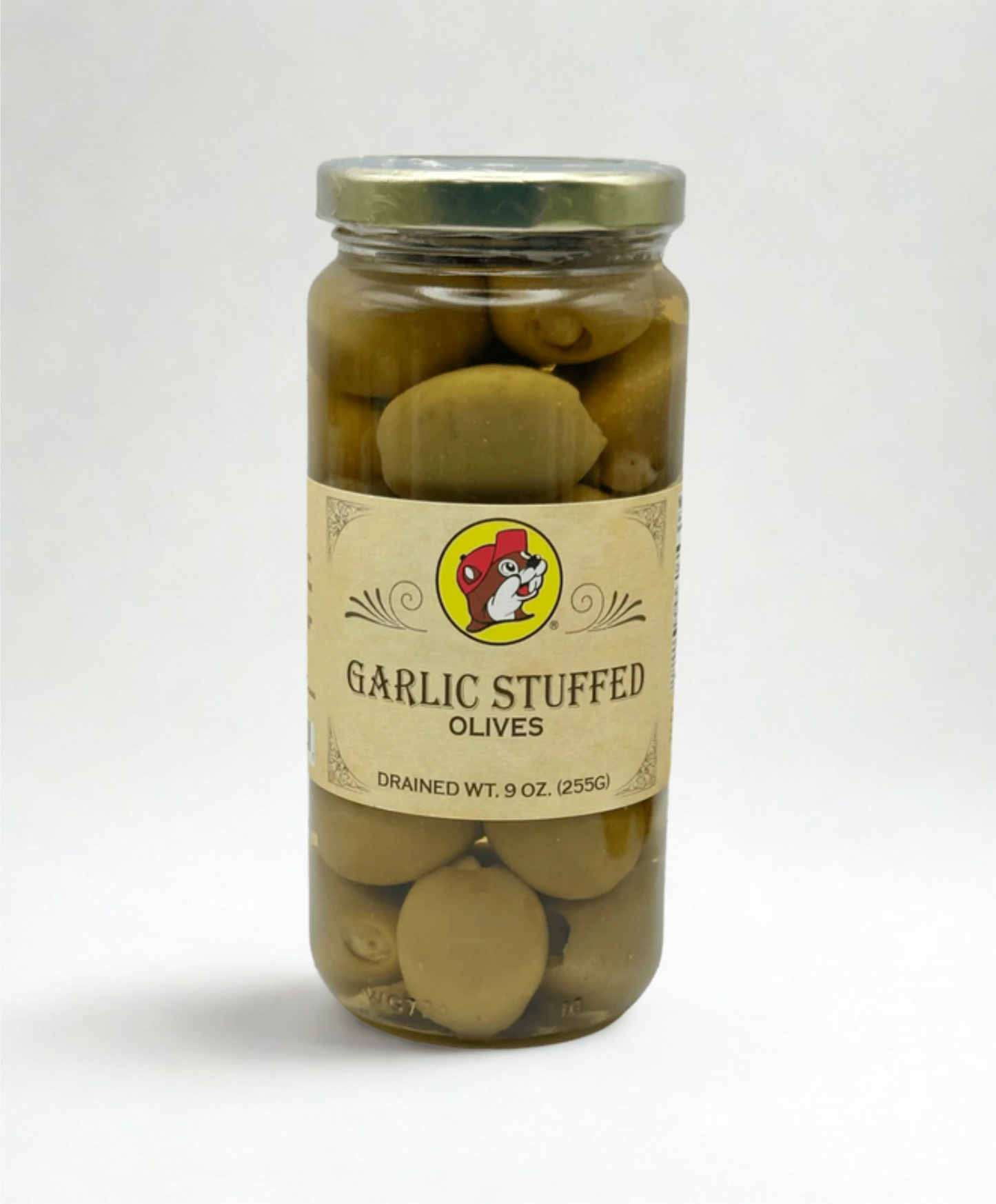 Jar of garlic stuffed olives on a wooden surface