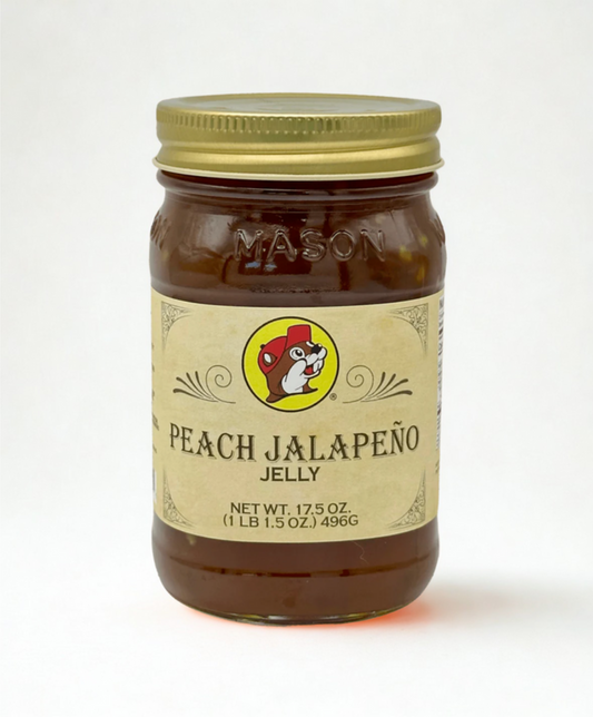 Jar of peach jalapeño jelly with a mason jar lid on a wooden surface